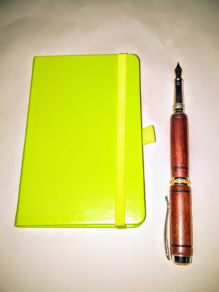 Lime green notebook and pen