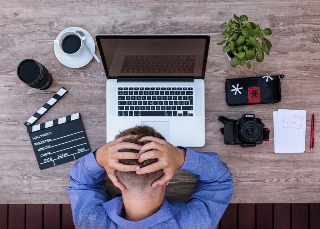 Worker clutching head in confusion